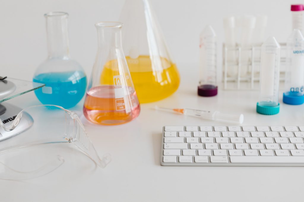 kaboompics chemistry lab glassware and test tubes at computer workstation 26201